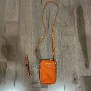Orange Prada mini wristlet crossbody bag